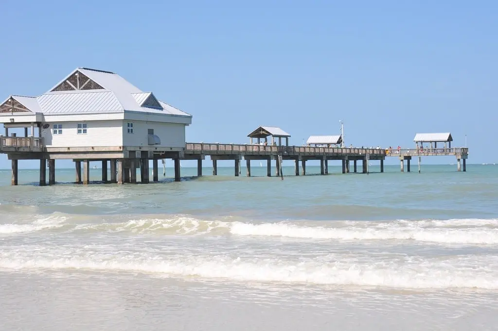 A beach with a pier and a building in the water. Florida boardwalk ocean -  PICRYL - Public Domain Media Search Engine Public Domain Image